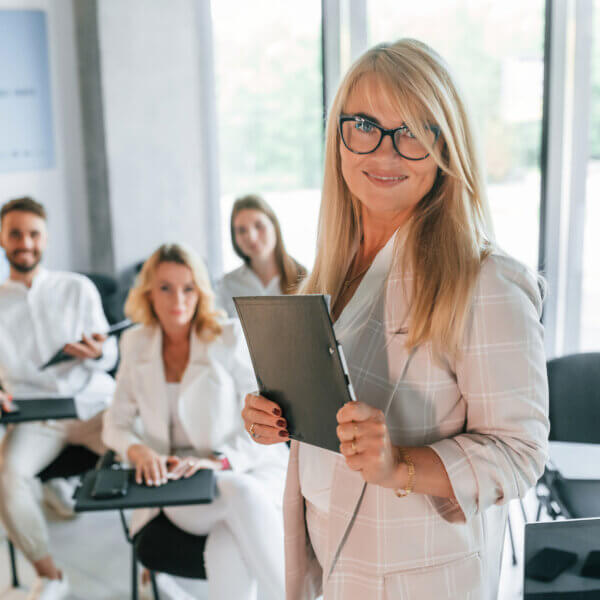 senior woman is making master class. group of professional business people is in the office